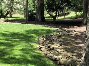 Stroll through the lush, park-like grounds, surrounded by a meandering stone pathway.