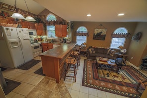 Enjoy cooking and relaxing in this well-appointed space with a central island, sofa, and coffee table.