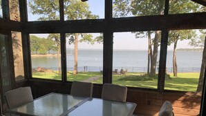 A glass-top table with chairs in a room with large windows overlooking a lake. - Very Best Sunset! Deep Water! 149ft waterfront-4BR/Sleeps 14, New Remodel (Mabank)