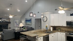 A modern kitchen with granite countertops, white cabinets, and stainless steel appliances. - Very Best Sunset! Deep Water! 149ft waterfront-4BR/Sleeps 14, New Remodel (Mabank)
