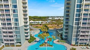 A high-rise hotel with a central swimming pool, multiple balconies, and a landscaped area with palm trees. - LONG BEACH RESORT Tower 2, 13th Floor 1 Bdr!!  Awesome Views! Beautiful Unit!!! ! (Panama City Beach)