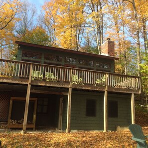 A rustic cabin with a balcony, surrounded by autumn foliage. - Okemoskichalet with Game Room & Hot Tub on Okemo Mt. 1 mile to base! Sleeps 12 (Ludlow)