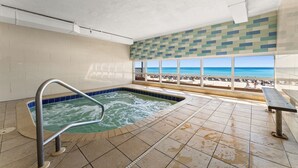 An indoor swimming pool with a view of the beach. - Tidewater Beach Resort 2009 Last minute Discounts. Bunk bed room (Panama City Beach)