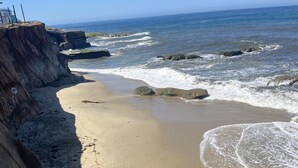 A concrete staircase leading down to a sandy beach with waves crashing onto the shore. - Oceanfront with incredible views.
Last minute discounts Available (San Diego)