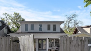 A two-story house with a covered porch and a brick pathway leading to the entrance. - Heart of 12th South -  1 bed, 1 bath Cozy Suite in Nashville (Nashville)