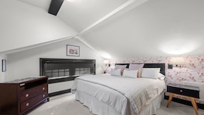 A bedroom with a bed, a dresser, a nightstand, and a window with blinds. - Heart of 12th South -  1 bed, 1 bath Cozy Suite in Nashville (Nashville)