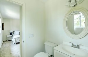A bathroom with a toilet, sink, and mirror. - Fantastic Contemporary ,Min to Narr beach. (Narragansett)