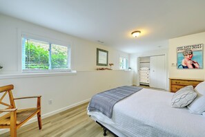 A bedroom with a bed, a chair, a window with blinds, a wardrobe, and a poster on the wall. - Fantastic Contemporary ,Min to Narr beach. (Narragansett)