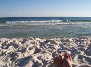 A sandy beach with waves in the background. - 2BR 2 BA 5th floor beachfront condo. Call Now! (Gulf Shores)