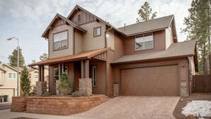 A two-story house with a garage, a covered porch, and a landscaped front yard. - Relax in the Pines at the Flagstaff Base Camp (Flagstaff)