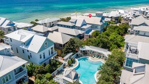 A resort with multiple buildings, a swimming pool, and a view of the ocean. - Upscale Home with Breathtaking Gulf Views Steps to Beach + Pool w/7 Beach Bikes! (Inlet Beach)