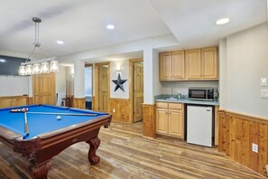 A room with a pool table, wooden cabinets, a microwave, and a refrigerator. - Free Pool Heat on All New 2026 Reservations (Corolla)