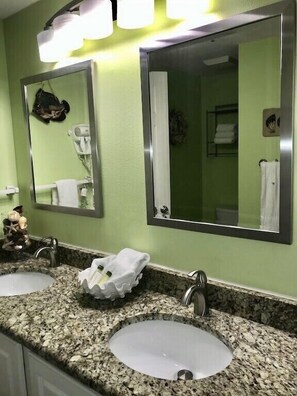 A bathroom with two sinks, a mirror, and a towel rack. - Direct Beach Front Tropic Isles 604 (Gulf Shores)