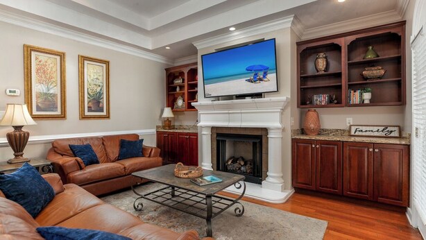 A living room with a fireplace, a television, and a sofa. - Condo pool garage short walk to beach (Myrtle Beach)