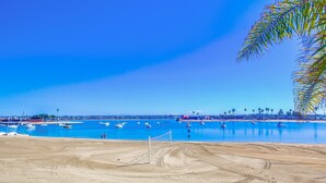Uma praia com uma área arenosa e um céu azul límpido.
