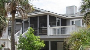 A two-story house with a balcony, a covered porch, and a visible staircase. - 709 Bluefish - Ocean Front (Saint Helena Island)