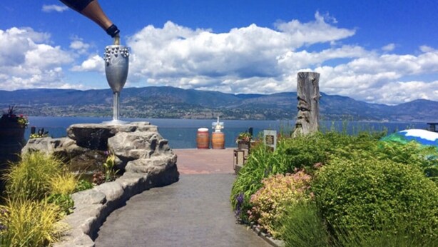 A pathway leading to a scenic overlook with a clear view of mountains and a lake.
