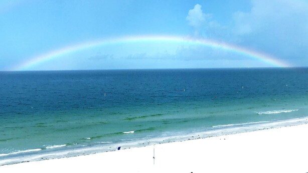 A beach with a rainbow over the ocean. - Right on the Gulf! Beautiful white sandy beachfront! Safe, quiet, and friendly! (Treasure Island)
