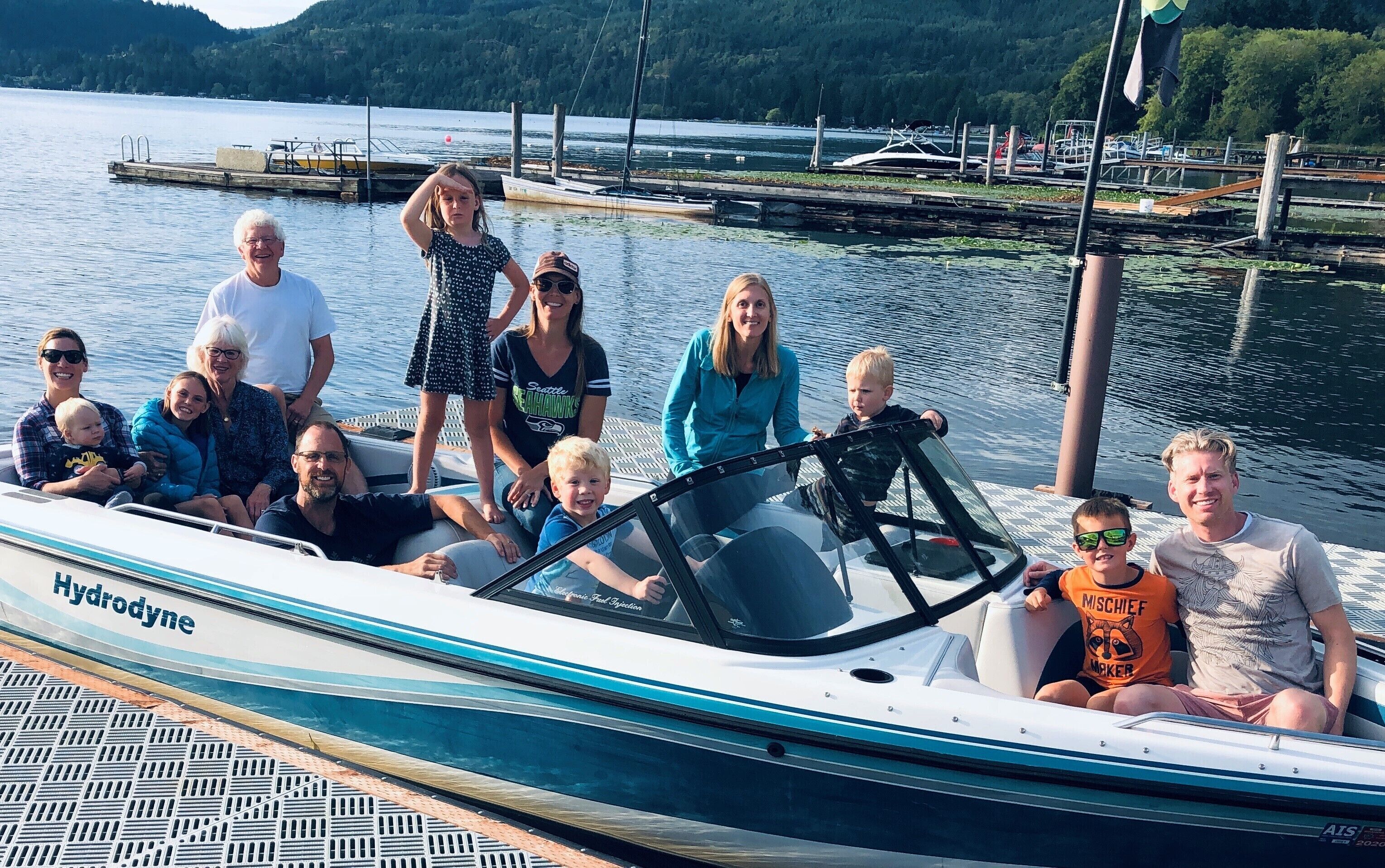 A group of people on a boat with a name "Hydrodyne" on the side.