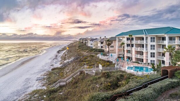 A beachfront hotel with a pool, multiple balconies, and a view of the ocean. - Stay on the Beach! Guest Favorite | Excellent Reviews | Chairs/Umbrella Included (Santa Rosa Beach)