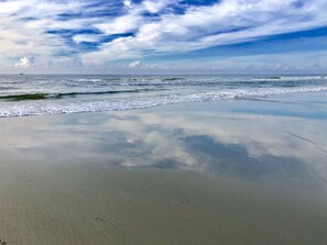 A beach with a calm sea and a clear sky. - Pelican Hub, a beach house in beautiful Sunset Beach, 1 block from beach access! (Sunset Beach)