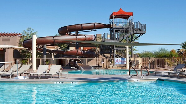 Enjoy a refreshing swim in the pool surrounded by lounge chairs and umbrellas.