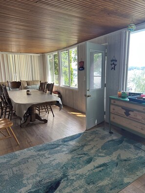 A dining area with a large table, chairs, and a view through the door. - Family And Pet-Friendly On Waubeesee Lake ~ Includes Kayaks! (Wind Lake)