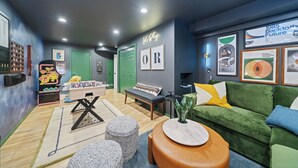 A room with a green sofa, a small table, a bench, a neon sign, and framed artwork on the wall. - Spacious 4BD Beach House - Pet-Friendly - Hot Tub! (Manzanita)