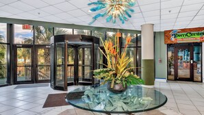 A lobby with a glass table, a rotating door, and a Town Center sign. - Oceanfront Condo just steps to the beach, Free parking and no resort fees! (North Myrtle Beach)