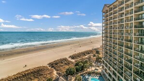 A beachfront hotel with a pool, beach access, and ocean views. - Oceanfront Condo just steps to the beach, Free parking and no resort fees! (North Myrtle Beach)