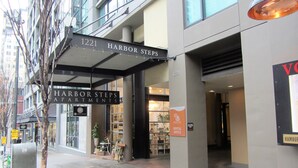 The exterior of Harbor Steps Apartments, including the entrance, signage, and a visible rental office. - Harbor Steps - 1 Blk to Pike Place Market, Waterfront - City Views! (Seattle)
