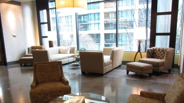 A spacious lobby with a modern design, featuring a mix of sofas and armchairs, a glass coffee table, and large windows offering a view of the cityscape. - Harbor Steps - 1 Blk to Pike Place Market, Waterfront - City Views! (Seattle)