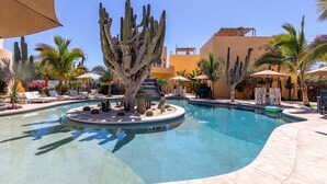 A pool area with a central cactus, lounge chairs, and umbrellas. - Puesta Del Sol Top Unit 2BR Condo Private Rooftop+ Steps to Cerritos Surf Beach (Cerritos Beach)