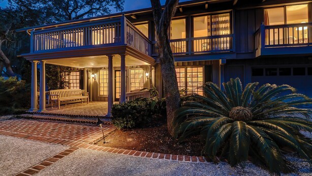 A two-story house with a covered porch and a large tree in front. - Peek of Blue – 2nd Row Sea Pines Home, Pool & Spa, Sleeps 17, 800 Ft to Beach (Hilton Head Island)