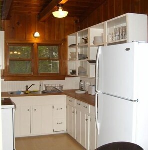 Fridge, microwave, coffee/tea maker, cookware/dishes/utensils