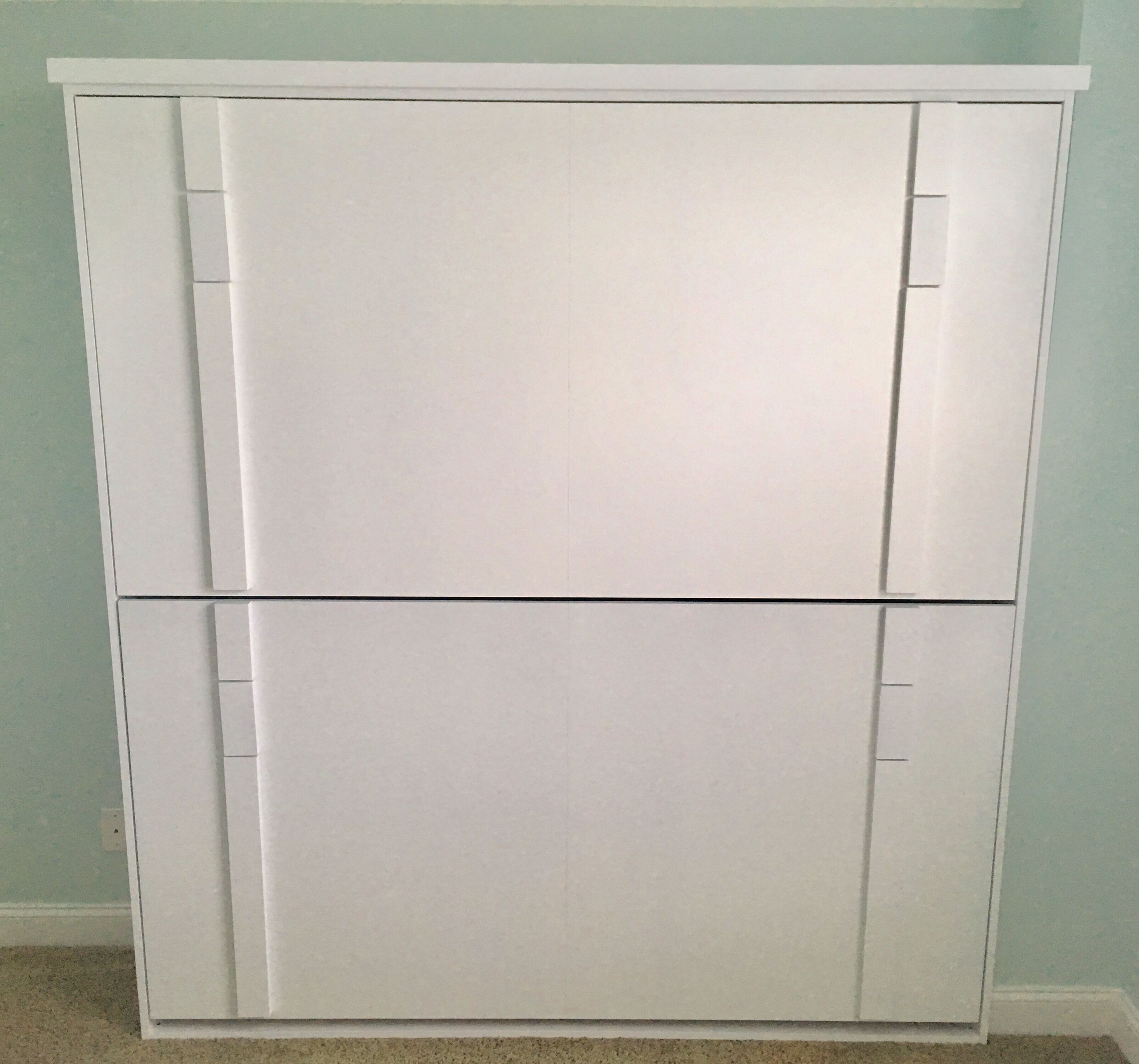 A white wardrobe with two doors and a flat mirror.
