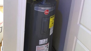 A water heater with a label reading "Performance Rheem" and a warning label. - GCB exceptional oceanview-2 story, 4BR4.5BA Beach House, private pool, sleeps 14 (Murrells Inlet)