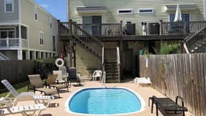 A backyard with a swimming pool, lounge chairs, and a wooden deck. - GCB exceptional oceanview-2 story, 4BR4.5BA Beach House, private pool, sleeps 14 (Murrells Inlet)