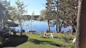 Relax in serene surroundings with a tranquil lake view, Adirondack chairs, and a rustic gazebo.