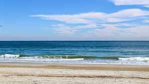 Ein Strand mit Sand und dem Meer.