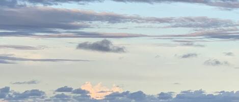 A beach with a view of the ocean and sky.