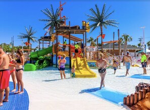 A water park with slides, palm trees, and people enjoying the facilities. - Magnificent Oceanfront!! Great Views Up & Down the Beach
NO CLEANING OR HOST FEE (Myrtle Beach)