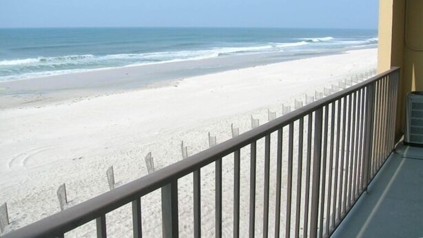 A balcony with a view of a sandy beach and ocean. - Beachfront - 2 bedrooms for price of one! (Pensacola)