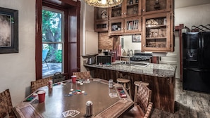 A kitchen with a wooden island, a stove, and a refrigerator.