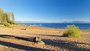 A beach with a stone pathway, a small hill, and a clear view of the sea and mountains. - Big 5Bd Pool Tbl, Hot Tub, Hiking, 10min to Beach (tahoe Vista)