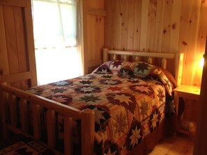 Amish made furniture and hand made quilt in downstairs bedroom.