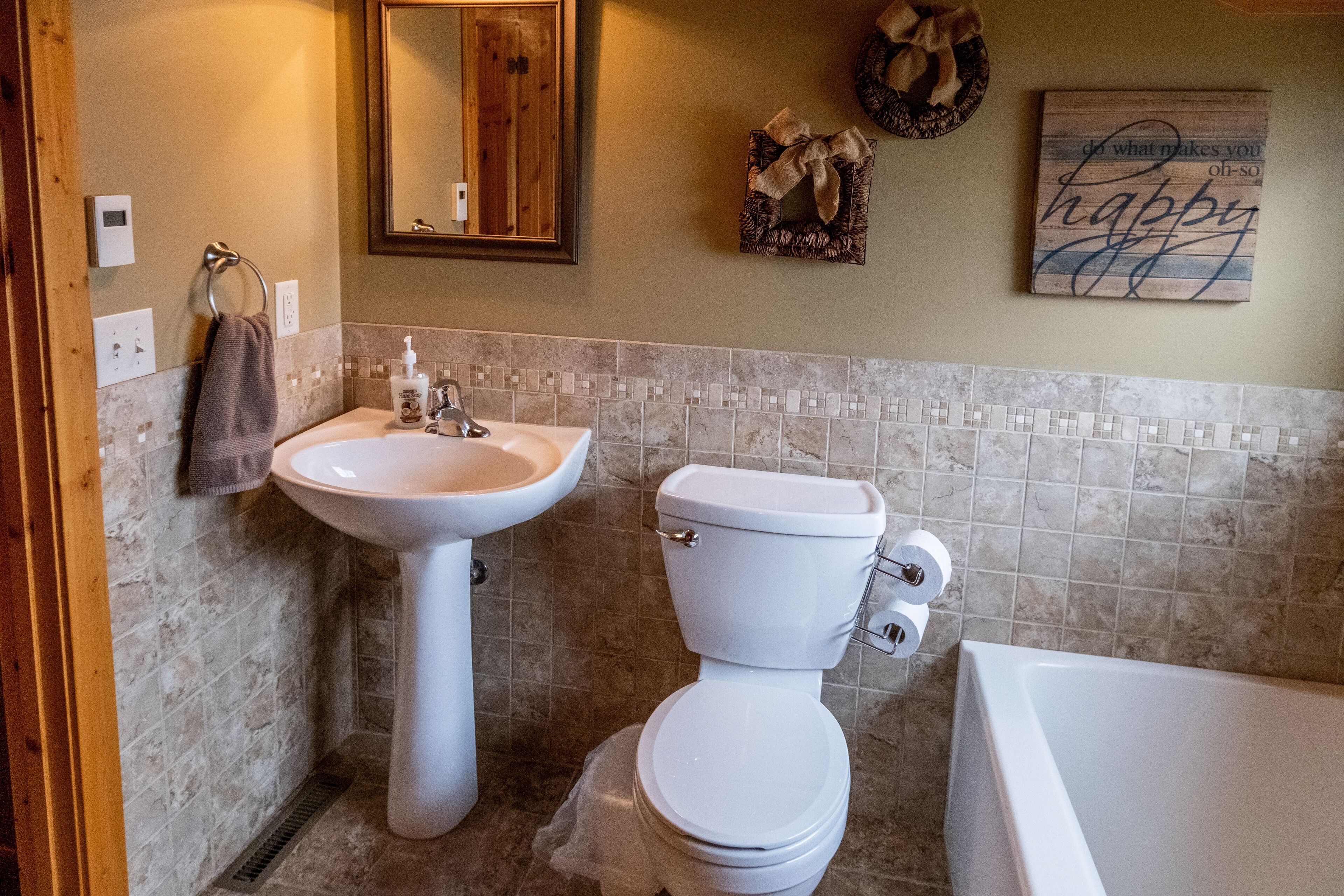A bathroom with a sink, toilet, and bathtub.
