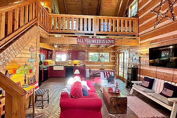 Welcome to the cabin! The Great Room offers group seating, TV, dining, back deck