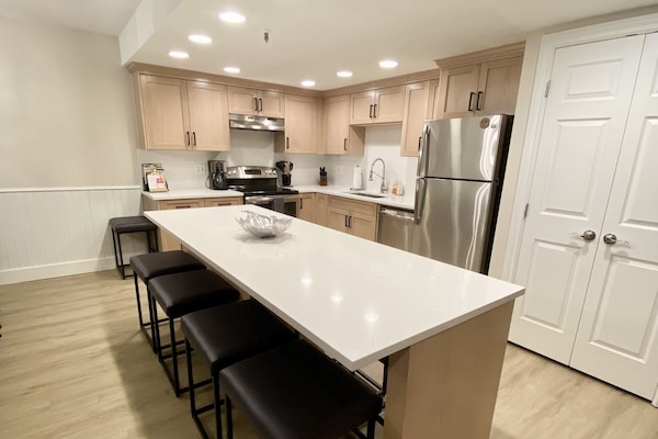 New white oak cabinets, quartz countertops & backsplash w/island bar to seat 8