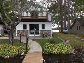 A two-story house with a deck, stone accents, and a private property sign. - Lakeside vacation rental on Musser lake in north central WI (Phillips)
